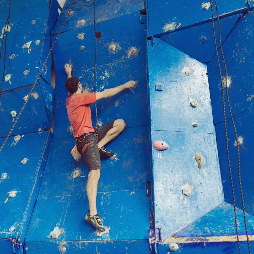 Fit man on a rock climbing wall